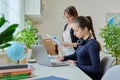 Teenage girl studying, female teacher with textbook helps tells teaches