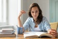 Teenage girl studying reading book at home Royalty Free Stock Photo