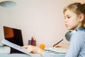 Teenage girl studying something using computer and headphones at home Royalty Free Stock Photo