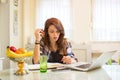 Teenage girl studying using books and laptop at home. Royalty Free Stock Photo