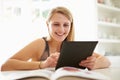 Teenage Girl Studying Using Digital Tablet At Home Royalty Free Stock Photo