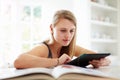 Teenage Girl Studying Using Digital Tablet At Home Royalty Free Stock Photo