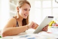 Teenage Girl Studying Using Digital Tablet At Home Royalty Free Stock Photo