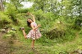 Teenage girl in summer dress dancing in front of ruins