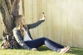 Teenage girl taking a selfie with a cell phone Royalty Free Stock Photo