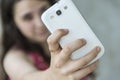 Teenage girl taking a selfie with her phone Royalty Free Stock Photo