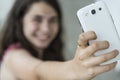 Teenage girl taking a selfie with her phone Royalty Free Stock Photo