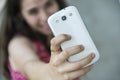 Teenage girl taking a selfie with her phone Royalty Free Stock Photo