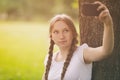 Teenage girl taking selfie using mobile phone in Royalty Free Stock Photo