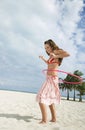 Teenage Girl Twirling Hula Hoop On Sandy Beach Royalty Free Stock Photo