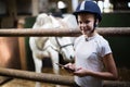 Teenage girl using digital tablet in the stable Royalty Free Stock Photo