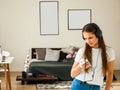 Teenage girl using headphone and holding smart phone listening to music Royalty Free Stock Photo