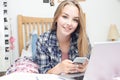 Teenage Girl Using Mobile Phone Whilst Doing Homework Royalty Free Stock Photo