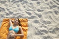 Teenage Girl Using MP3 Player Lying On Beach Towel Royalty Free Stock Photo