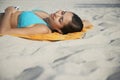 Teenage Girl Using MP3 Player Lying On Beach Towel Royalty Free Stock Photo