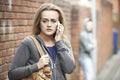 Teenage Girl Using Phone As She Feels Intimidated On Walk Home