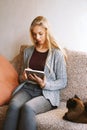 Teenage girl using tablet computer at home Royalty Free Stock Photo