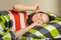 Teenage girl wakes up at home in bed Royalty Free Stock Photo