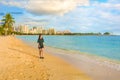 Teenage girl walking at empty Ala Moana Beach at sunset Royalty Free Stock Photo