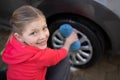 Teenage girl washing a car on a sunny day Royalty Free Stock Photo