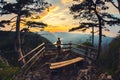 Teenage girl watching sunrise over the mountain range in summer Royalty Free Stock Photo