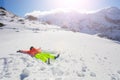 Teenage girl wear ski clothes lay in star shape Royalty Free Stock Photo