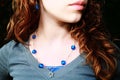 Teenage girl wearing blue stone necklace