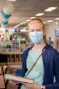 A girl wearing face mask at the llibrary during the COVID-19 pandemic