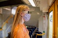 Teenage girl wearing face mask inside for the train. Sydney trains transport NSW during Covid-19 pandemic. Mandatory face masks in