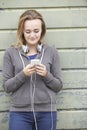 Teenage Girl Wearing Headphones And Listening To Music In Urban Royalty Free Stock Photo