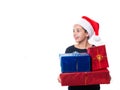 Young girl holding Christmas presents and wearing a Santa hat Royalty Free Stock Photo