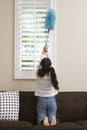 Teenage Girl Whisking At Window