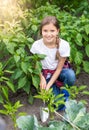 Teenage girl working at garden with hand shovel