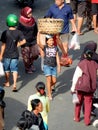 A teenage girl works as a porter in traditional market