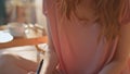 Teenage girl writing diary in sunlight closeup. Hands holding pen noting in book Royalty Free Stock Photo