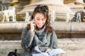 Teenage girl / young student looking at her notebook and smiling Royalty Free Stock Photo