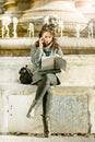 Teenage girl / young student looking at her notebook and talking on the phone Royalty Free Stock Photo