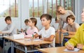 Teenage girls and boys exercising during lesson in school