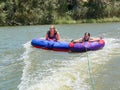 Teenage girls in donuts.(water raft)