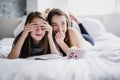 Teenage girls eating popcorn and watching horror movie on tv at home Royalty Free Stock Photo