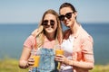 Teenage girls or friends with drinks in summer Royalty Free Stock Photo