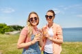 Teenage girls or friends with drinks in summer Royalty Free Stock Photo