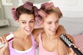 Teenage girls with hair in curlers Royalty Free Stock Photo