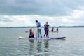 Teenage girls learning to paddle board