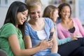 Teenage girls looking at a mobile phone Royalty Free Stock Photo