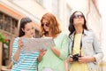 Teenage girls with map and camera Royalty Free Stock Photo