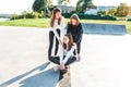 Teenage girls play having fun skateboard summer, autumn spring city, weekends after school. Happy smiling resting after Royalty Free Stock Photo