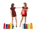 Teenage girls in red dresses with shopping bags Royalty Free Stock Photo