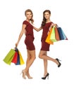 Teenage girls in red dresses with shopping bags Royalty Free Stock Photo