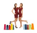 Teenage girls in red dresses with shopping bags Royalty Free Stock Photo